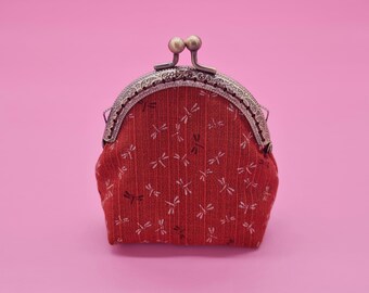 Small clip wallet made of rust-red cotton with dragonflies and metal frame