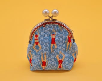 Small clip wallet made of light blue cotton with floats and metal frame