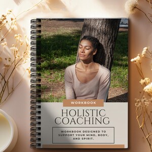 May include: A workbook titled "Holistic Coaching" with the subtitle "Workbook designed to support your mind, body, and spirit." The cover features a woman with her eyes closed, sitting under a tree in a forest.
