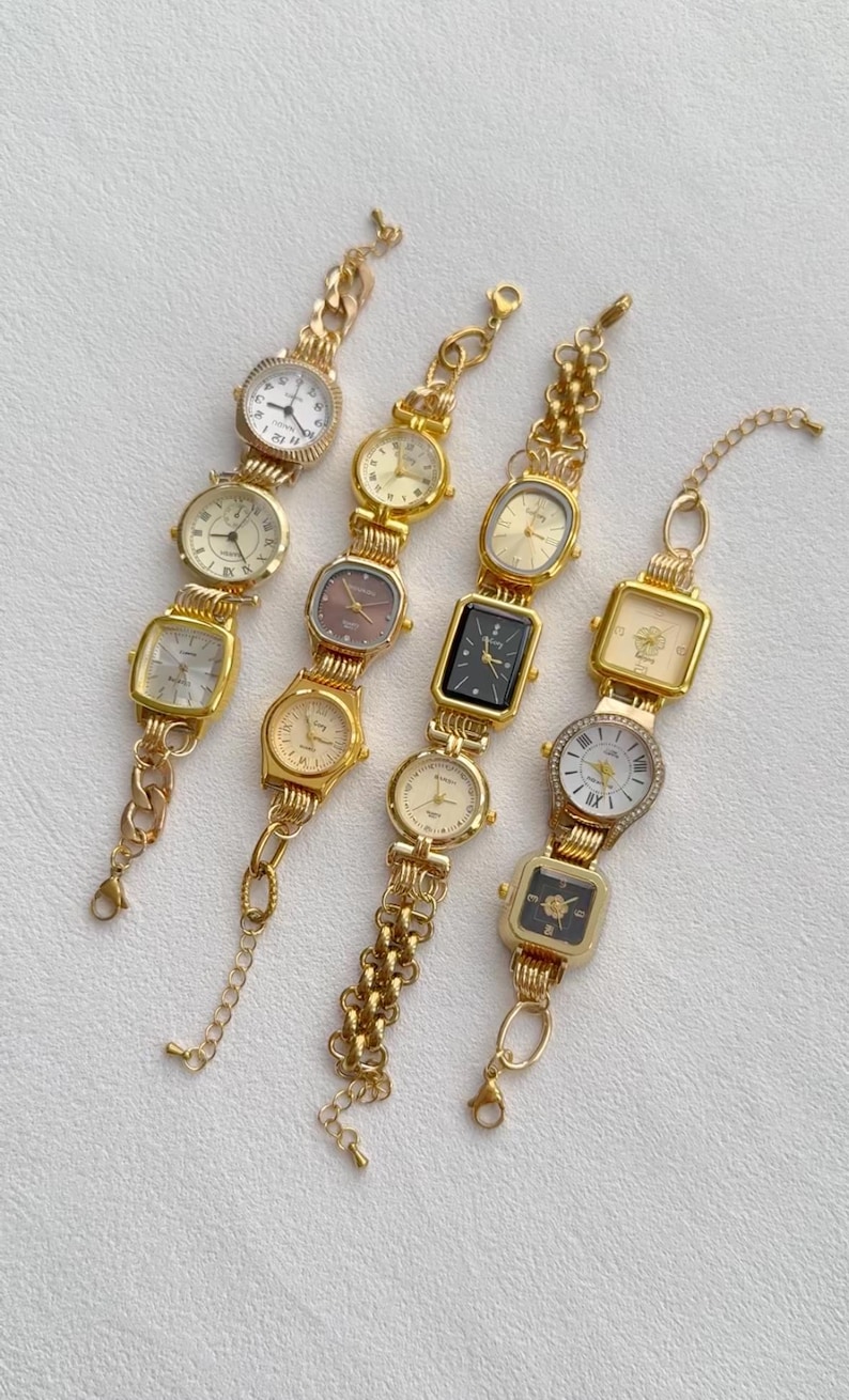 May include: Four gold-tone wristwatches with different face designs. The watches have gold-tone metal bands with various chain link patterns.