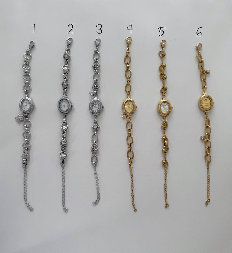 May include: Six bracelet watches with oval faces and different chain styles. The watches are silver and gold-toned, some with charms and dangling chains. The watch faces have a classic, minimalist design, suitable for a range of styles.