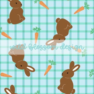 May include: A repeating pattern featuring brown bunnies and orange carrots with green tops on a light blue and green plaid background. The text "wild blossom design" is in a cursive font.