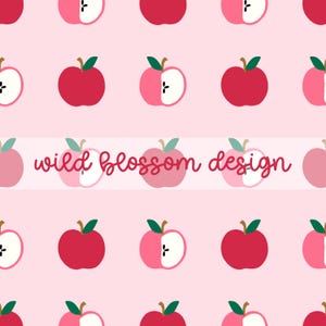 May include: A repeating pattern on a light pink background featuring whole red apples and halved apples with white flesh and black seeds. A horizontal white band across the center displays the text wild blossom design in red script.