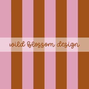 May include: A repeating vertical striped pattern featuring alternating bands of light pink and deep brown. A horizontal semi-transparent band overlays the center, displaying the text wild blossom design in a brown, cursive, lowercase font.
