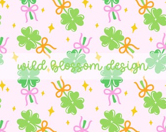 May include: A repeating pattern of green shamrocks tied with pink and orange ribbons, scattered with yellow star shapes, on a light pink background. The text "wild blossom design" is in a cursive font.