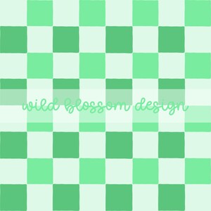 May include: A digitally created checkerboard pattern in shades of green and white. The text "wild blossom design" is written in a cursive font across the center of the image. The squares are evenly sized and arranged in a grid.