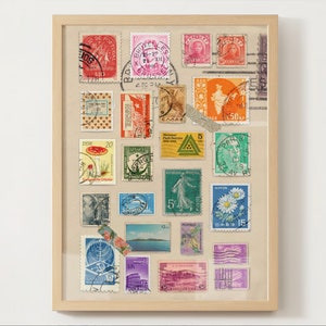 May include: A framed collection of vintage postage stamps from around the world. The stamps feature a variety of designs, including flowers, landscapes, and portraits. The frame is made of wood and has a light brown finish.