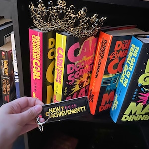 New Achievement Keychain – Dungeon Crawler Inspired – Machine Embroidered on Marine Vinyl