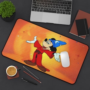 May include: A yellow and orange mousepad with a cartoon image of Mickey Mouse dressed as a wizard. Mickey is wearing a red robe and a blue hat with stars. The background is a yellow and orange gradient with stars.