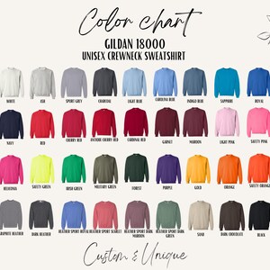May include: A colour chart of Gildan 18000 unisex crewneck sweatshirts in a range of colours, such as white, grey, blue, red, and black. The text "Custom & Unique" is at the bottom. The image is on a cream background.
