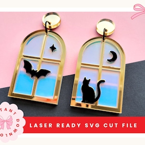 Può includere: Un paio di orecchini a forma di finestra ad arco con cornici dorate e pannelli iridescenti. Uno presenta un pipistrello nero e una stella, l'altro un gatto nero e una mezzaluna. Testo: INSTANT DOWNLOAD LASER READY SVG CUT FILE.