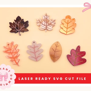 May include: An assortment of laser-cut leaf shapes in shades of brown, gold, and pink. The leaves are displayed on a light orange backdrop. The text at the bottom reads "LASER READY SVG CUT FILE".