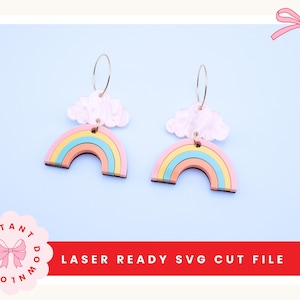 May include: A pair of colorful rainbow earrings with gold hoops and cloud-shaped tops. The earrings feature a pastel color palette of pink, yellow, blue, and orange. The text "LASER READY SVG CUT FILE" is displayed in a red rectangle.