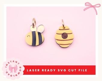 Puede incluir: Dos pendientes con temática de abeja, amarillos y negros, cortados con láser. Uno es una abeja con rayas negras y una cara sonriente. El otro es una colmena. Los pendientes tienen aros dorados. El texto "LASER READY SVG CUT FILE" está en la parte inferior.