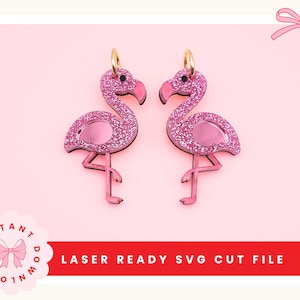 May include: A pair of pink glitter flamingo earrings with gold hoops. The earrings feature a mirrored centre and are set against a pink backdrop. The text "LASER READY SVG CUT FILE" is displayed at the bottom.