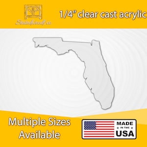 May include: A white outline of the state of Florida cut from 1/4 inch clear cast acrylic. The image includes the text "1/4" clear cast acrylic" and "Stectedwoods.co". The text "Multiple Sizes Available" and "MADE IN THE USA" are also included in the image.