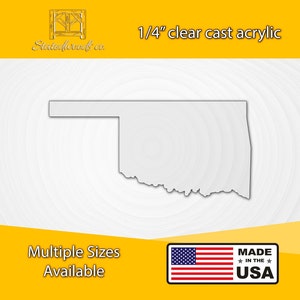 May include: A clear cast acrylic cutout of the state of Oklahoma. The state outline is white against a white background. The text "1/4" clear cast acrylic" is at the top of the image. The text "Multiple Sizes Available" is at the bottom left of the image. The text "MADE IN THE USA" is at the bottom right of the image with a small American flag to the left of the text.
