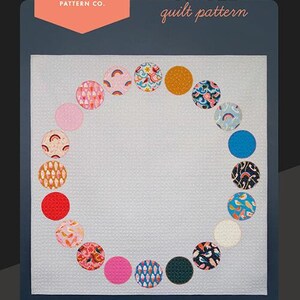 May include: A quilt pattern for a Social Circle quilt, featuring a circle of colorful fabric circles with different patterns. The pattern is by Ruby Star Society and designed by Melody Miller. The quilt measures 67 inches by 67 inches.