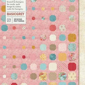 May include: A pink quilt pattern with the title "Bubbly Quilt" and the text "PATO77 featuring sunday brunch by basicgrey for moda. quilt design by audrey tanke for basicgrey. BASICGREY SEWING PATTERNS". The quilt pattern features a variety of colorful circles and octagons.