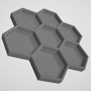 May include: A gray hexagonal tray with seven compartments. The tray is made of a smooth, matte material and has a slightly raised edge around each compartment.