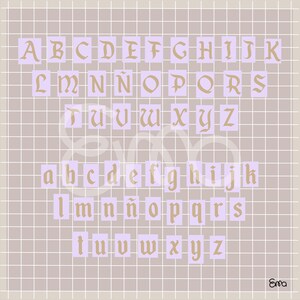 May include: A grid-patterned background with the alphabet in a vintage font. The uppercase and lowercase letters are in a gold color, set against lavender rectangles. The background is a light brown color with a grid pattern.