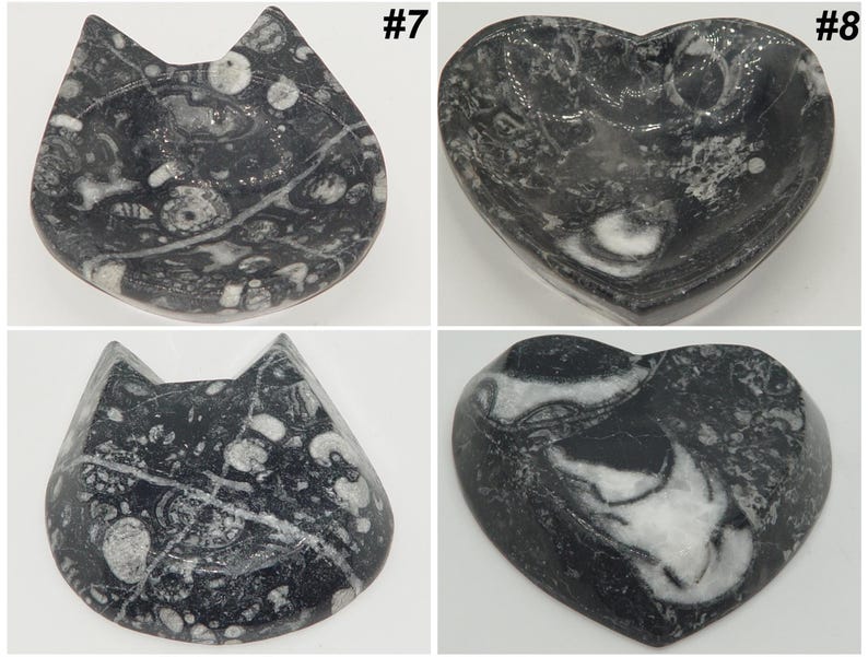 May include: Four decorative stone dishes. Two are cat-shaped, and two are heart-shaped. The dishes are black and white, with a marbled pattern. The cat-shaped dishes have pointed ears. The heart-shaped dishes have a smooth, curved shape. Each dish is labeled with a number.