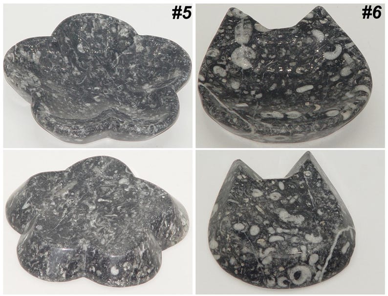 May include: Four decorative stone dishes. Two are flower-shaped, and two are cat-shaped. The dishes are dark gray with white and light gray marbling. The dishes are numbered #5 and #6.