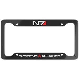 May include: Black metal license plate frame with the text "N7 SYSTEMS ALLIANCE" and a red and white N7 logo.
