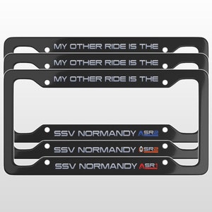 May include: Set of three black license plate frames with white text that reads "MY OTHER RIDE IS THE" and blue, orange, and red text that reads "SSV NORMANDY ASR2", "SSV NORMANDY OSRE", and "SSV NORMANDY ASR1".