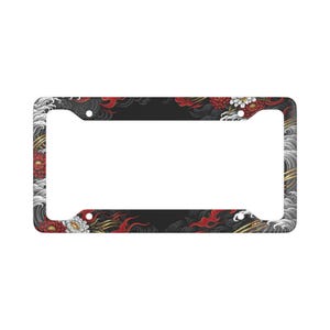 May include: Black license plate frame with a Japanese-inspired design. The frame features red and white floral patterns, gold accents, and stylized waves against a black background.