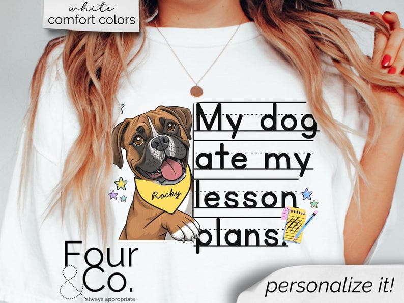 May include: White t-shirt with a cartoon illustration of a brown and white boxer dog wearing a yellow collar with the name "Rocky" on it. The text "My dog ate my lesson plans." is written in black on a white background with black lines.