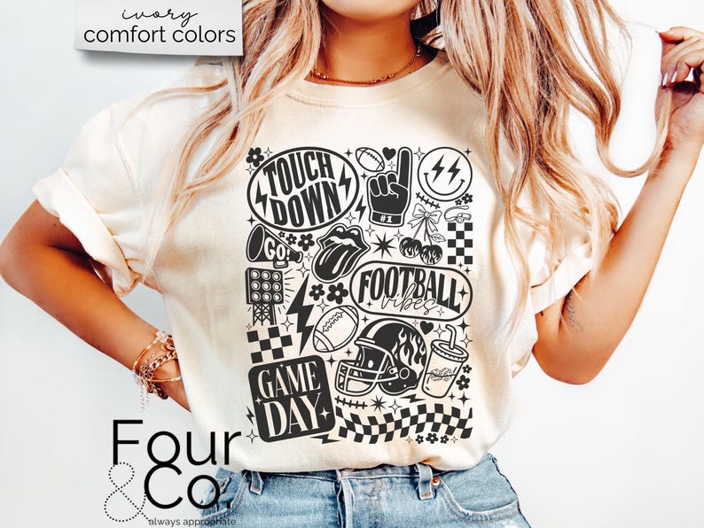 May include: Cream-colored t-shirt with a black and white graphic design featuring football-themed elements. The design includes the words "Touch Down", "Football Vibes", and "Game Day", along with footballs, a helmet, and a megaphone.