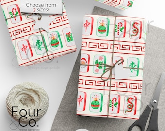 May include: Gift-wrapped presents with a festive Mahjong tile pattern in red, green, and white. The gifts are tied with twine and have blank tags. The wrapping paper features Christmas-themed tiles and the text "Choose from 3 sizes!"