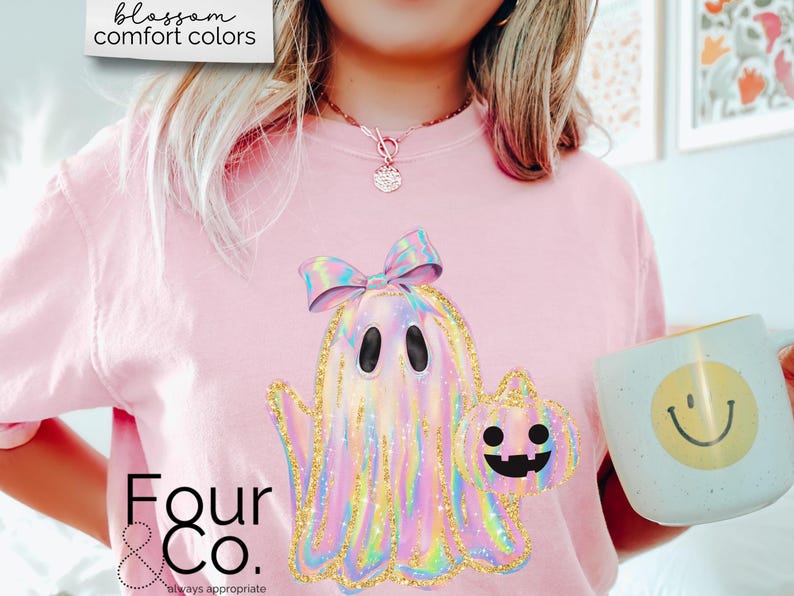 May include: Pink t-shirt with a holographic ghost wearing a bow and holding a pumpkin. The text "Four & Co. always appropriate" is on the bottom of the shirt.