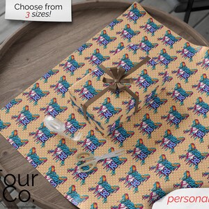 May include: Gift wrap featuring a repeating pattern of a stylized figure with the number "32" and the text "Jones". The wrapping paper is tan with a brown ribbon and bow. The text "Choose from 3 sizes!" is in the top left corner.