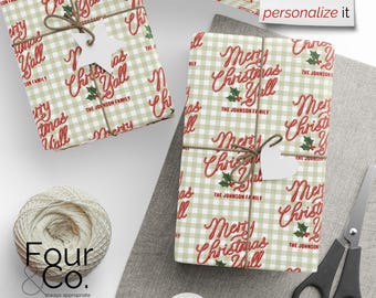 May include: Two wrapped gifts with "Merry Christmas Y'all" text on a green and white checkered background. Each gift is tied with twine and a white tag. A ball of twine and scissors are also visible.