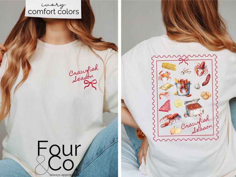 May include: A white t-shirt with a red "Crawfish Season" graphic on the front and a red stamp-like graphic with a variety of crawfish-related imagery on the back. The shirt is being modeled by a person wearing blue jeans.