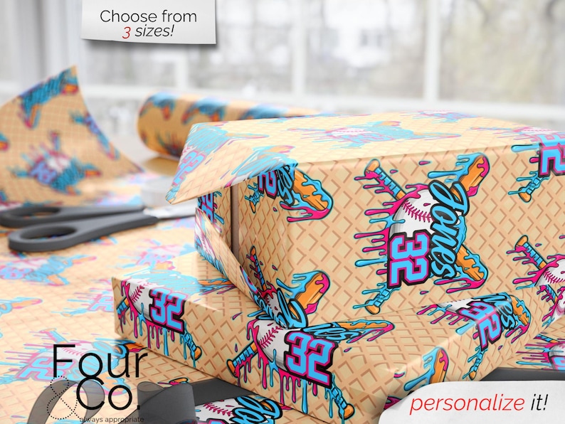 May include: Gift boxes and wrapping paper with a baseball theme. The design features a baseball bat, baseball, and the name "Jones" with the number "32" in blue and pink. The background is a waffle pattern. Text reads "Choose from 3 sizes!" and "personalize it!"