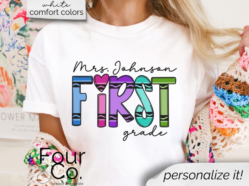 May include: White t-shirt with the text "Mrs. Johnson FIRST grade" in rainbow crayon colors. The text is surrounded by a heart.