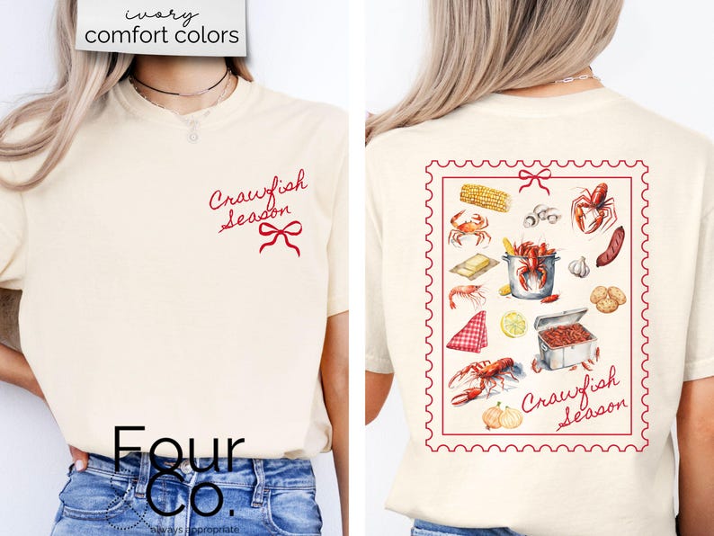 May include: A white t-shirt with the text "Crawfish Season" in red script on the front and a red bow. The back of the shirt has a red and white stamp design with the text "Crawfish Season" and illustrations of crawfish, corn, garlic, and other ingredients.
