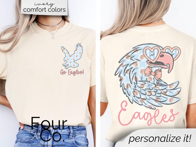 Pu&ograve; includere: T-shirt color crema con un design a forma di aquila. La parte anteriore mostra una piccola grafica di aquila con la scritta "Go Eagles!". Il retro presenta un'aquila pi&ugrave; grande con occhiali a forma di cuore e un papillon, con la parola "Eagles" sotto. La maglietta ha il testo "ivory comfort colors" in alto.