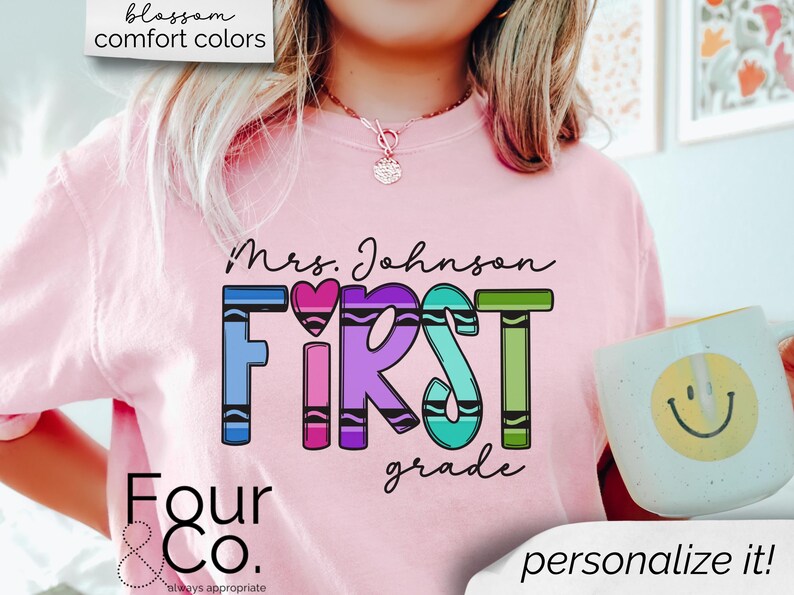 May include: Pink t-shirt with the text "Mrs. Johnson First Grade" in rainbow colors. The text is made to look like crayons. The shirt also has the text "Four & Co. always appropriate" at the bottom.