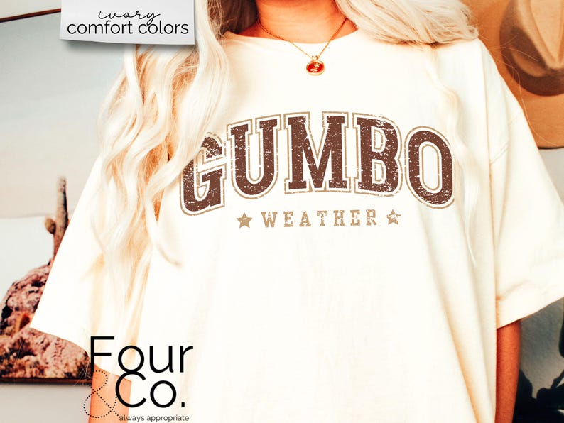 May include: A white t-shirt with a brown distressed graphic that says "GUMBO WEATHER" with stars on either side of the text. The text is in a vintage style font. The shirt is from Four & Co. and says "always appropriate" below the logo.