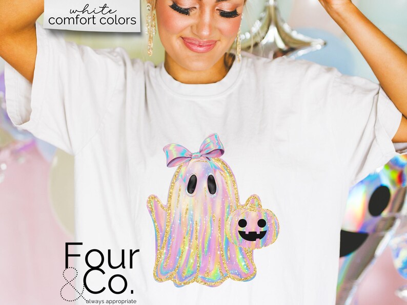 May include: White t-shirt with a holographic iridescent ghost holding a pumpkin. The ghost has a pink bow on its head. The text "Four & Co. always appropriate" is at the bottom of the shirt.