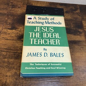 May include: A hardcover book titled A Study of Teaching Methods: Jesus the Ideal Teacher by James D. Bales, with a green and cream cover featuring the subtitle The Techniques of Successful Christian Teaching and Soul Winning, positioned below a black power strip.