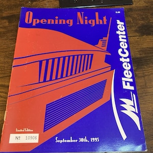 May include: A rectangular program booklet titled Opening Night for the FleetCenter, dated September 30th, 1995. The cover features a stylized orange building graphic on a blue background, with the text Limited Edition and number 10906.
