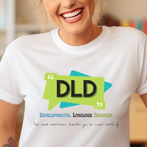 May include: White t-shirt with a green and blue speech bubble graphic that says "DLD" and the text "Developmental Language Disorder - the most common disorder you've never heard of."