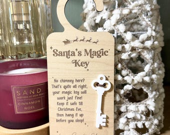 May include: A wooden Christmas ornament shaped like a door hanger, featuring the text "Santa's Magic Key" and a decorative key. The ornament includes a message about the key's use and is designed for hanging before Christmas Eve.