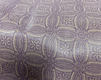 May include: Purple and cream patterned fabric with a repeating design of interlocking circles and small flowers.