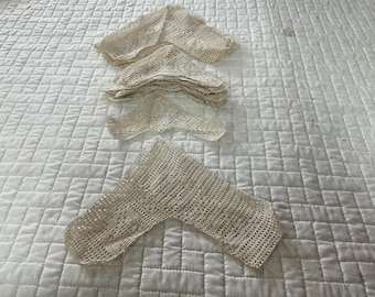 May include: A set of three crocheted lace doilies in a cream color. The doilies are delicate and intricate, with a floral pattern. They are perfect for adding a touch of elegance to any home.
